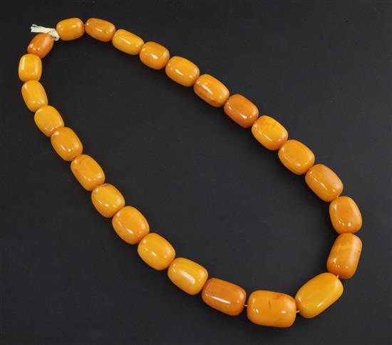 A single strand graduated barrel shaped amber bead necklace, 56cm.